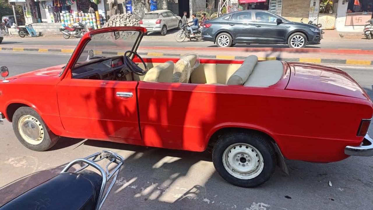 Red NE118 open-top vintage convertible for wedding and baraat booking in Udaipur